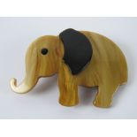 An overlaid plastic brooch in the style of Lea Stein in the form of an elephant, 7cm wide.