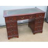 A reproduction pedestal desk having inset green leather writing surface, 122 x 60cm.