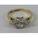 An 18ct gold diamond cluster ring having six round cut brilliant diamonds in marquise pattern with