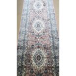 A silk pink and blue ground runner having geometric design, 372 x 96cm.