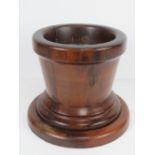 A fine quality turned fruitwood stepped planter with lead insert. Planted 22cm dia, base 27cm.