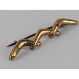 An Australian 9ct rose gold brooch in the form of three boomerangs, slightly a/f, 1g.