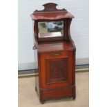 An Edwardian mahogany perdonium fireside coal scuttle with bevelled edge mirror over,