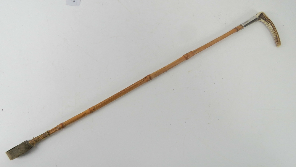 A ladies horn handled and HM silver collared bamboo riding crop with leather tail, 63cm in length.