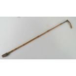 A ladies horn handled and HM silver collared bamboo riding crop with leather tail, 63cm in length.
