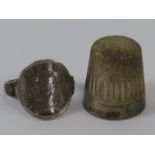An HM silver thimble, hallmarked for Birmingham, together with a three pence coin ring. Two items.