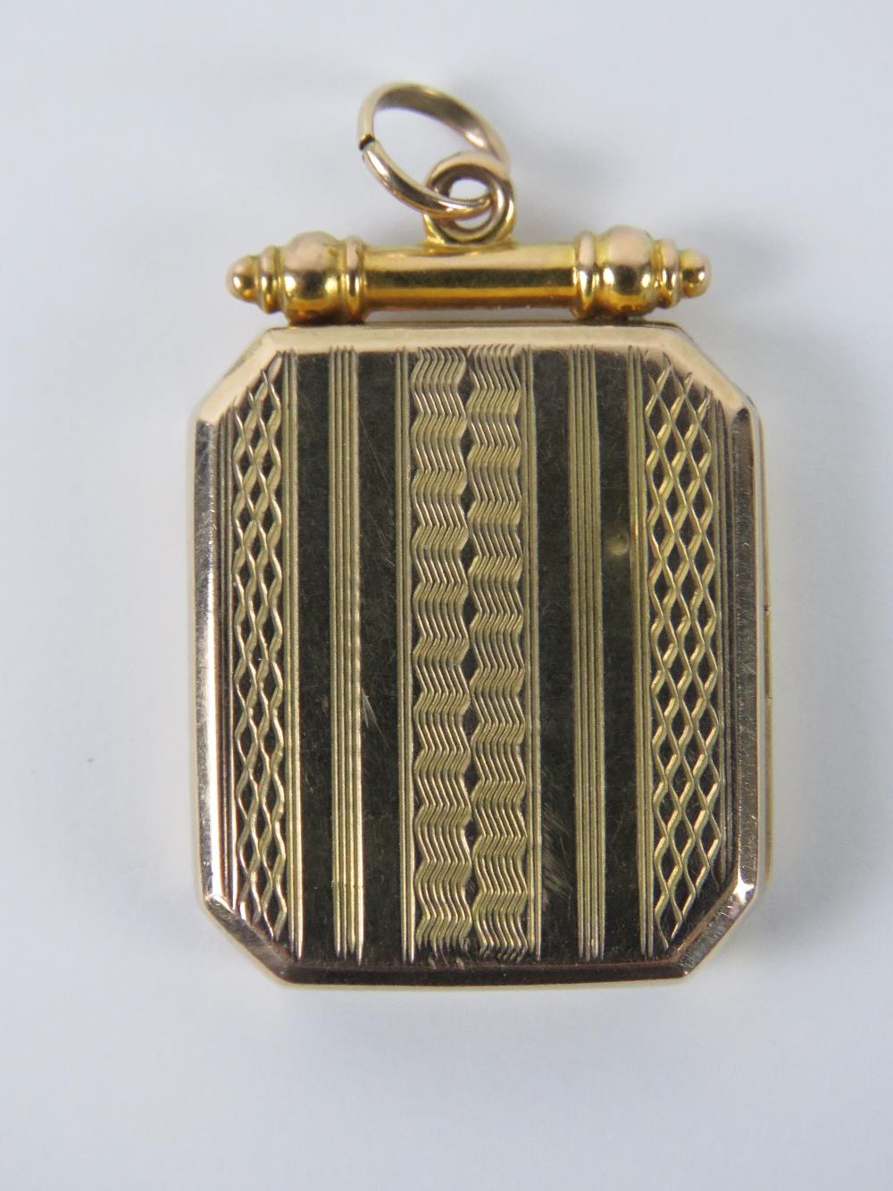 An unusual Victorian/Edwardian octagonal locket having unengraved scroll style cartouche to front