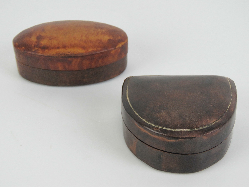 Two leather covered stud boxes manufactured by and stamped Harrods,