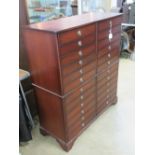 A contemporary chest of twelve drawers being two banks of double decked drawers,