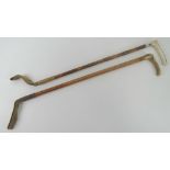 A pair of horn handled and bamboo riding crops one having HM silver collar,