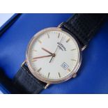 A Rotary wristwatch in box with paperwork, cream dial with date aperture on original Rotary strap,