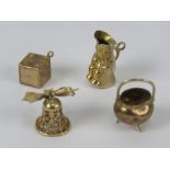 Four 9ct gold charms, each hallmarked 375, being dice, cauldron, toby jug and bell. 8.3g.