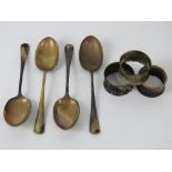 A quantity of HM silver table spoons and HM silver napkins rings having sustained fire damage.