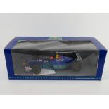 A 1997 Red Bull Sauber Petronas scale model racing car in box.