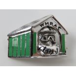 An HM silver WMRAC brooch in the form of a dog within enamelled kennel with 'chequered flag' roof.