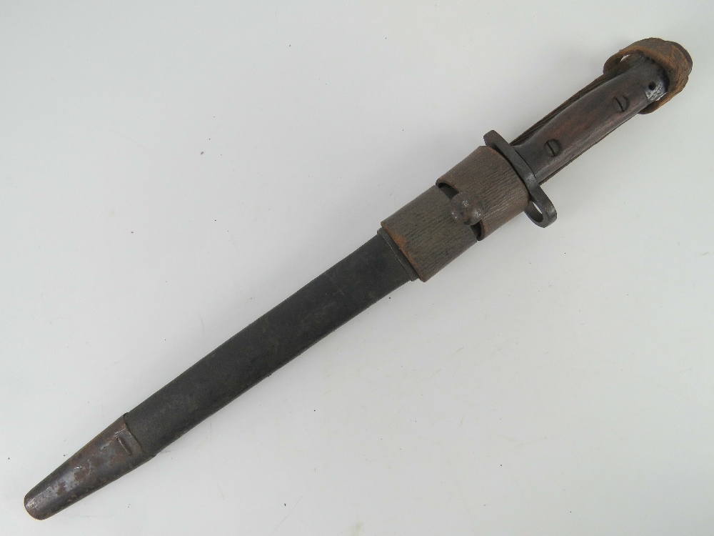 An Indian SMLE bayonet having wooden grips and 30.5cm blade, with leather scabbard and frog.