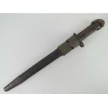 An Indian SMLE bayonet having wooden grips and 30.5cm blade, with leather scabbard and frog.