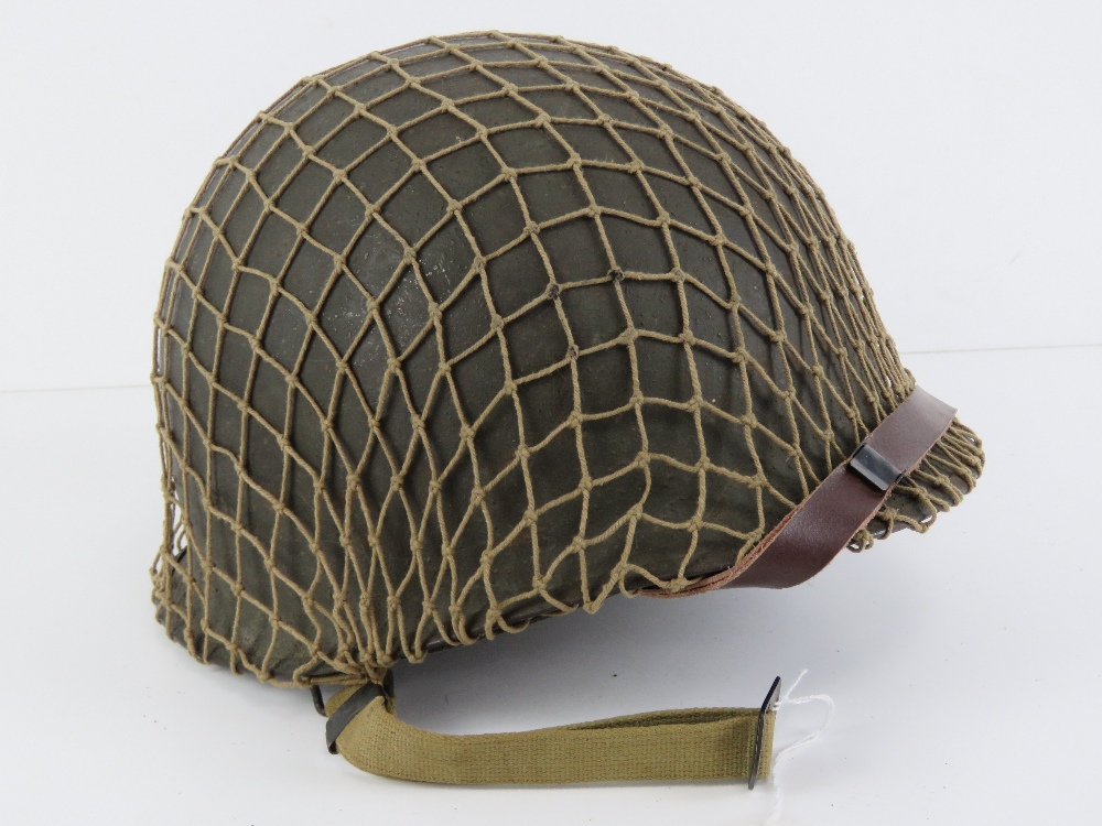 A WWII US Army McCord helmet having heat stamp that dates it to 1945,