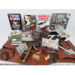 A large quantity of books including the WWII, First world war, a box of DVDs of WWII, gun cases,