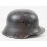 A WWI German M17 helmet having repainted camouflage, no chin strap.