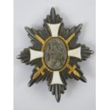 A WWI German Deutsches Feld-EhrenZeichen badge having white enamel cross to front,