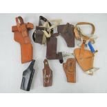 A quantity of seven holsters including a Broomhandle mauser, a colt pythan, s&w,