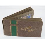 A cigarette card album containing a quantity of cards for regiments and planes,