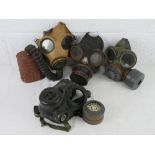 A quantity of four gas masks inc a WWII British Military long tube version,