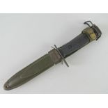 A Vietnam era M16 bayonet with scabbard and canvas frog.