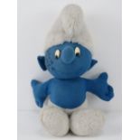 A Chad Valley plush Smurf signed by Barron Knights, creators of the Smurf song.