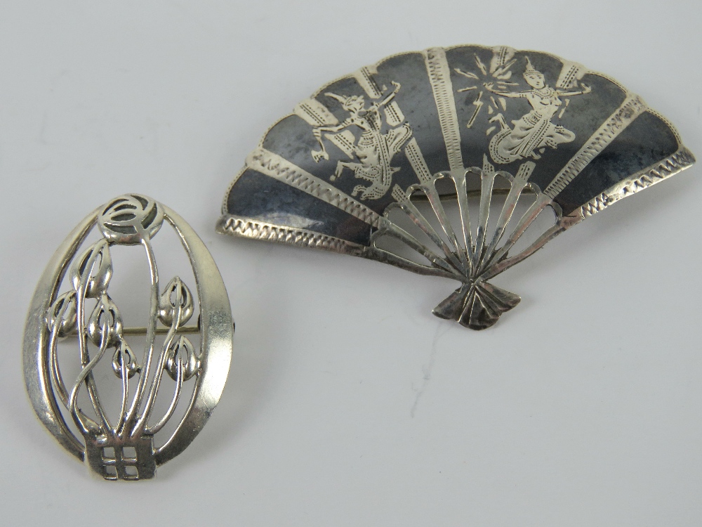 A Charles Rennie Mackintosh inspired silver brooch, oval frame with floral pattern within,