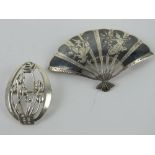 A Charles Rennie Mackintosh inspired silver brooch, oval frame with floral pattern within,