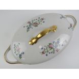 A French lidded turn having white ground with delicate pink and blue floral decoration upon,