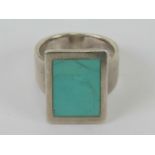 A HM silver turquoise ring, panel at front measuring 1.9 x 1.4cm, hallmarked for Sheffield, size M.
