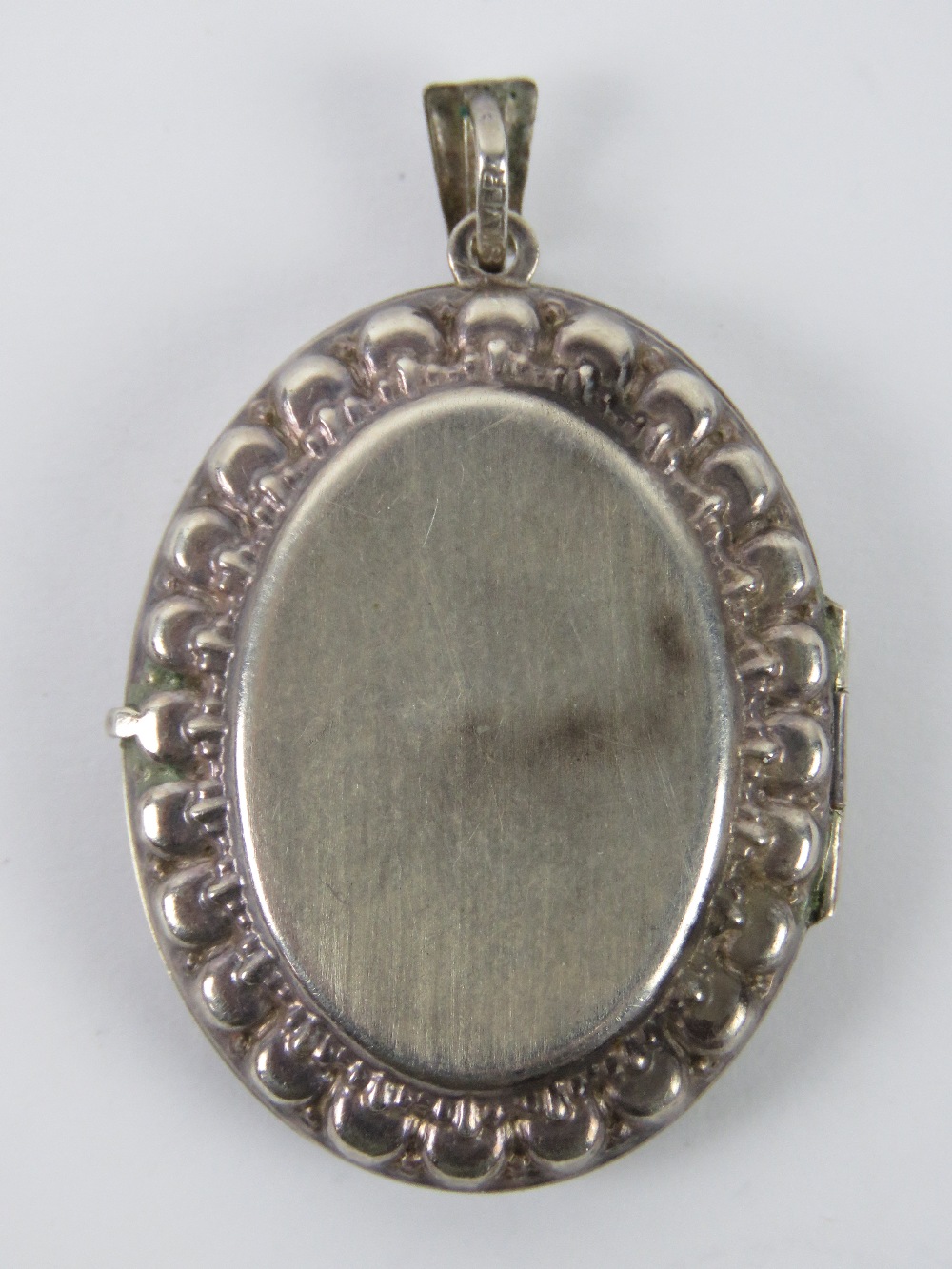 A large silver locket having floral engraving to front, - Image 2 of 4