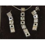 A suite of silver jewellery comprising articulated square sectional pendant set with white stones,