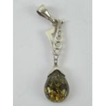 A large silver and green Baltic amber pendant,