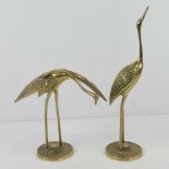 A pair of cast brass oriental style cranes 19 and 30.5cm high respectively.