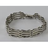 A silver gate link bracelet having London hallmarked heart padlock clasp.