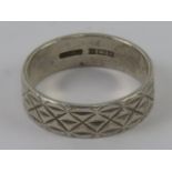 A HM silver ring having continuous engraved pattern to the 6mm wide band, hallmarked Birmingham,