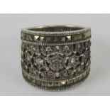 A silver ring set with marcasites and white stones, wide front measuring 1.