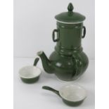 An unusual green and white ceramic hot chocolate pot including filter and two drinking saucers,