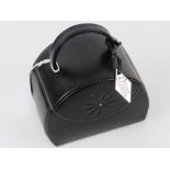 A contemporary black leather jewellery case having various compartments within. 12 x 8 x 13cm.