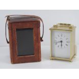 A vintage leatherette travel clock case having velvet lining, strap a/f.