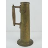 Trench Art; a brass shell casing converted for use as a handle jug or vase, 30cm high.