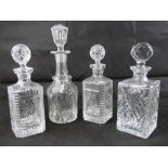 A quantity of four assorted decanters being a pressed glass pair complete with stoppers,