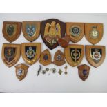 A quantity of assorted wooden plaques having police and military insignia upon,