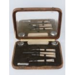 An Art Deco manicure set in 'crocodile skin' fitted box.