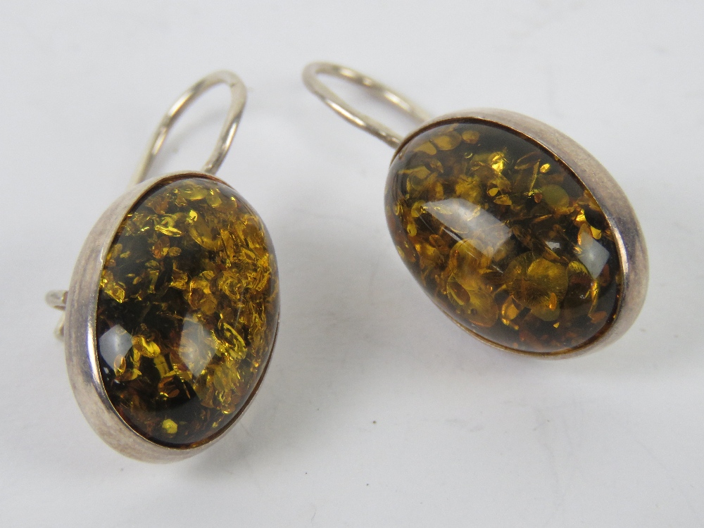 A pair of Baltic Amber earrings, each cabachon approx 1.8 x 1.