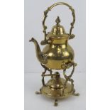 A brass teapot with spirit burner and stand all standing 31cm high.